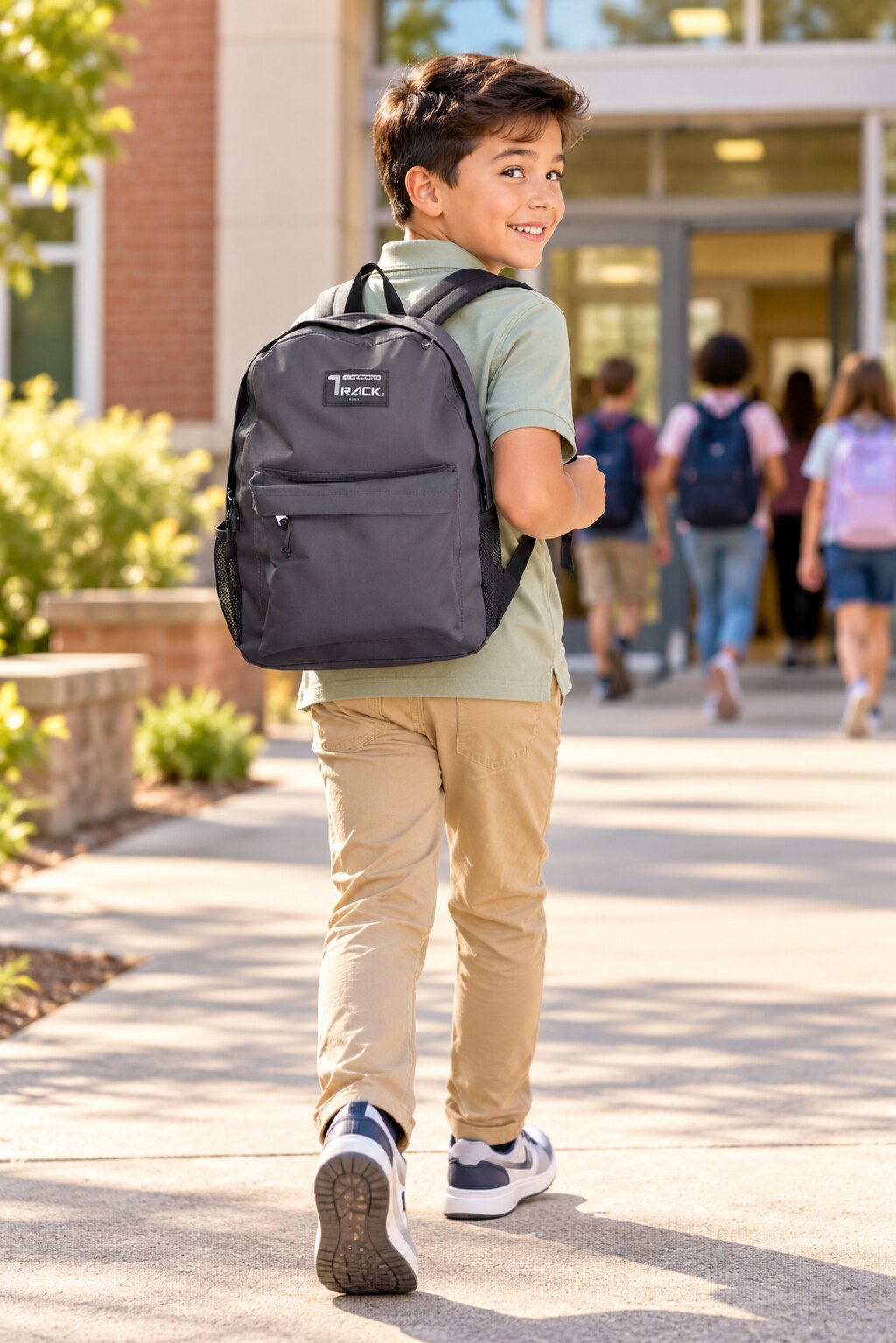 Boy walking to school with a charcoal SD Designer school backpack